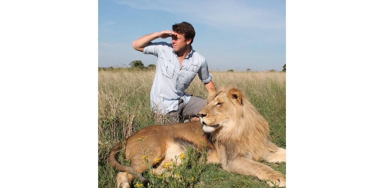 Brent Folan with a lion in Antelope Park